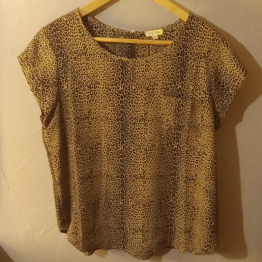 Animal print sheer top with gold button on back.